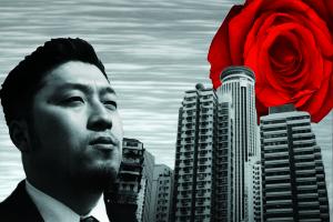 A black and white composite image of a young Japanese man’s face in three-quarter profile. He has short hair and light facial hair and is wearing a suit. Behind him are tall buildings against a gray static background. A bright red rose hovers behind the buildings like the sun.