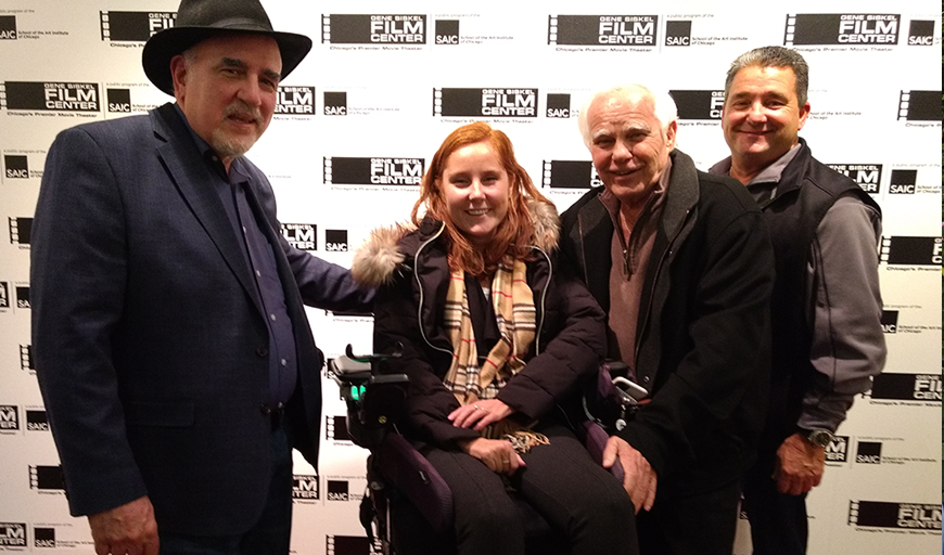 New Day Member George Bogdanich, stands next to three members of the Hogan family, smiling for the camera. Bill Hogan, second from right, is featured in the film Betrayal: When the Government Took Over the Teamsters Union. He stands next to his son Bob and his granddaughter, Kelly, who sits in a wheelchair at a screening of George’s documentary film at the Gene Siskel Film Center in Chicago.