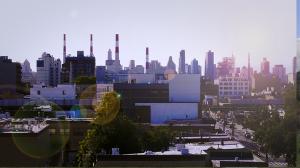 Still from How To Power A City shows towers and skyscrapers of a downtown just beyond many lower buildings and tall, leafy trees.