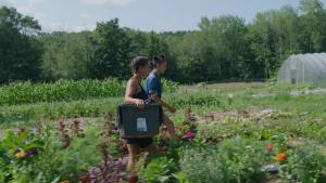 Leah and Naima walking in the middle of a field